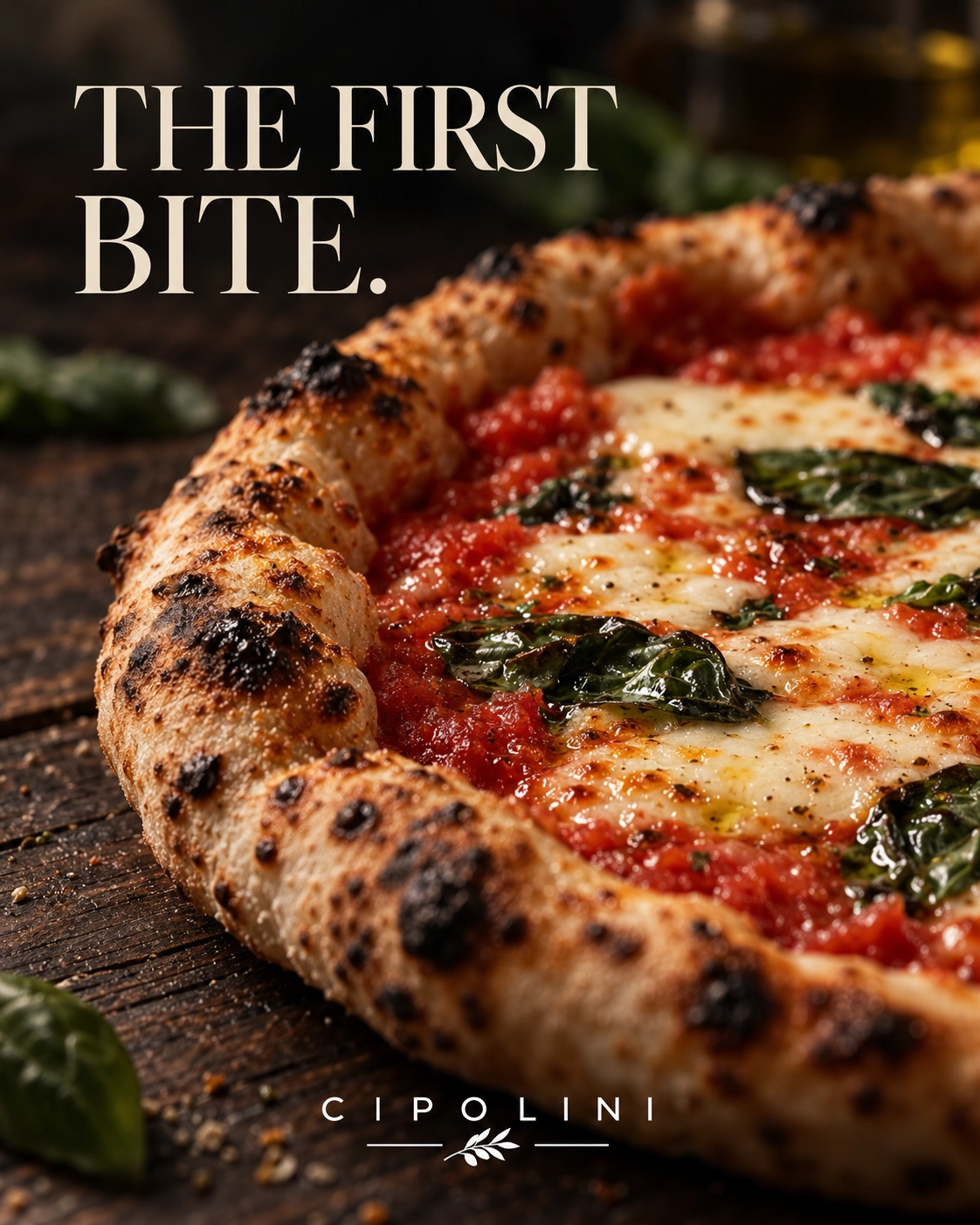 Close view of a baked pizza with a blistered crust, tomato and basil